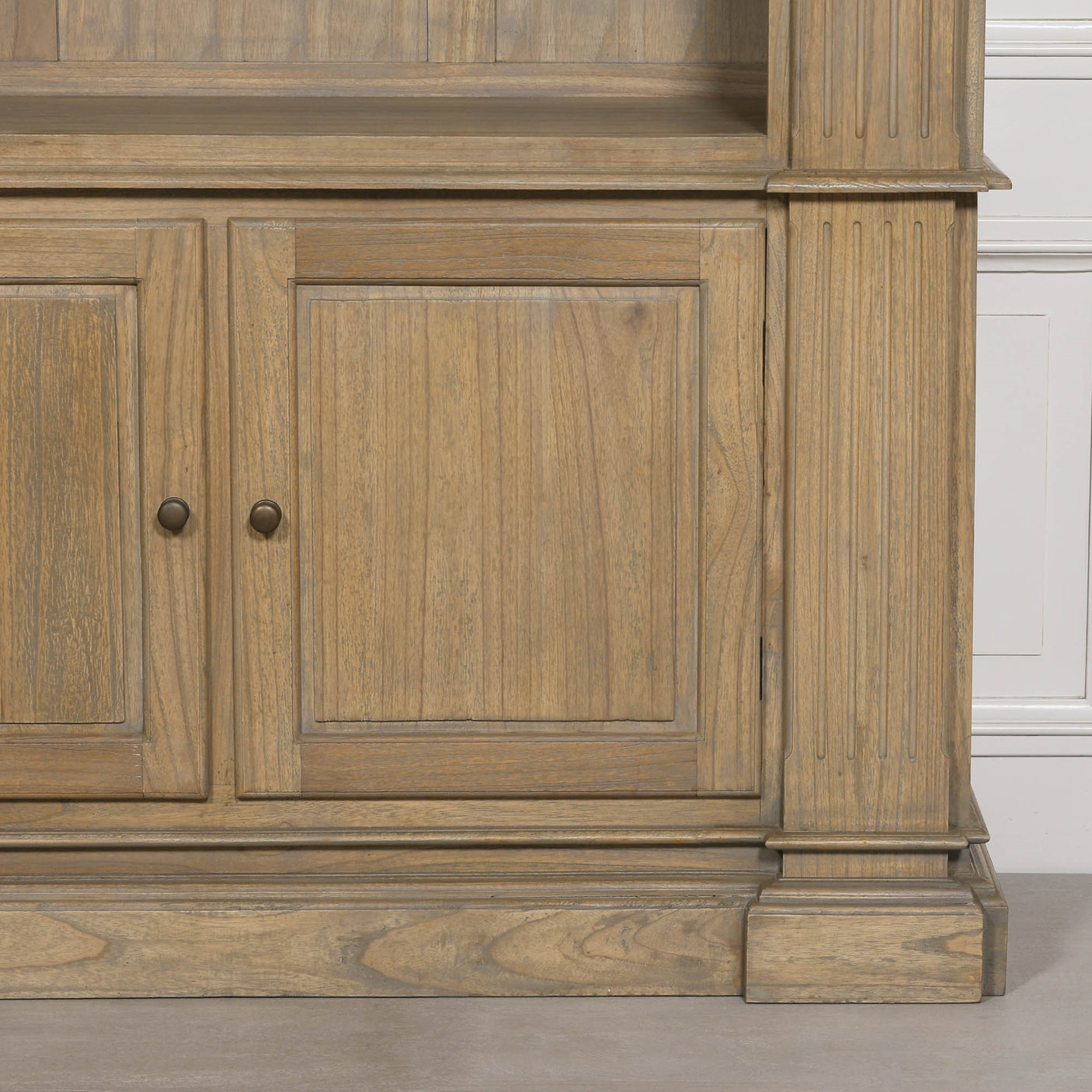 Large rustic open bookcase with two lower cabinet doors and detailed woodwork.