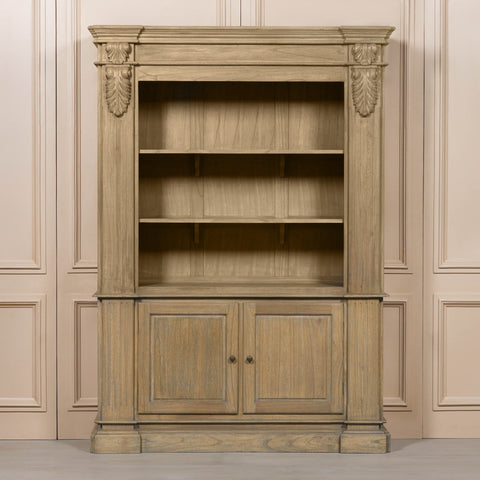 Large rustic open bookcase with decorative detailing and two lower doors, set against a neutral background.