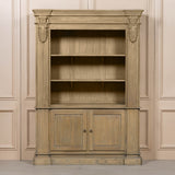 Large rustic open bookcase with decorative detailing and two lower doors, set against a neutral background.