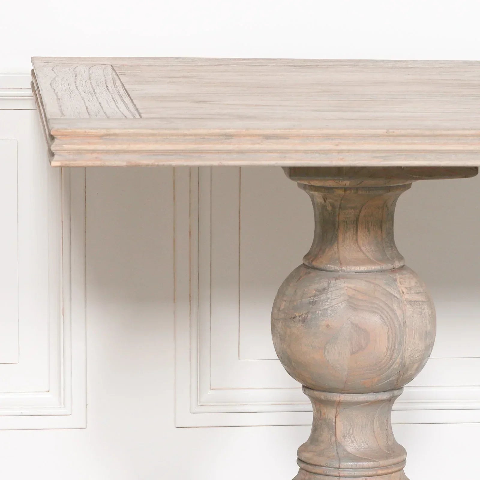 Rustic wood dining table with carved pedestal base and light natural finish