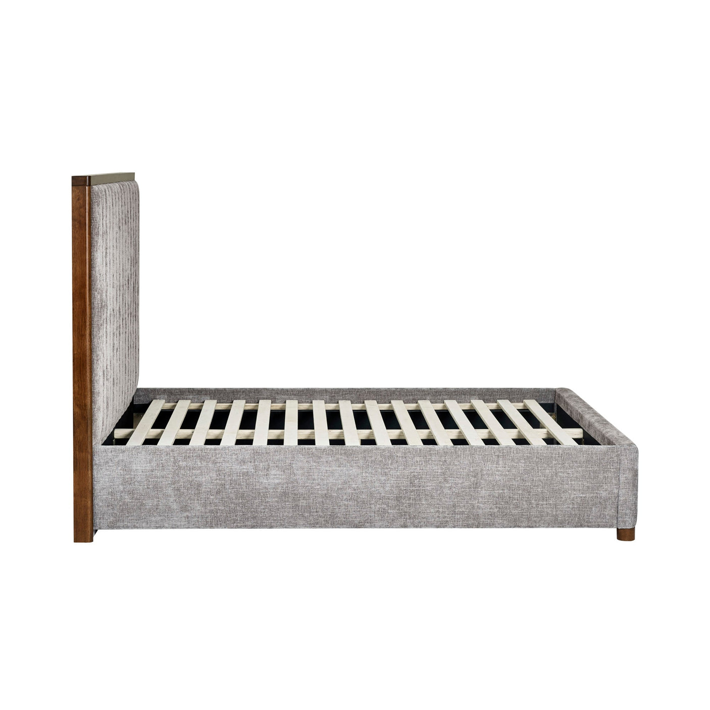 Close-up side view of tall channel-tufted grey fabric headboard with dark wood frame
