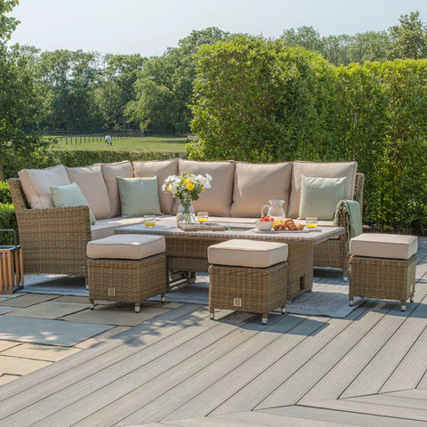 Rattan outdoor corner sofa set with beige cushions, matching stools, and coffee table on patio