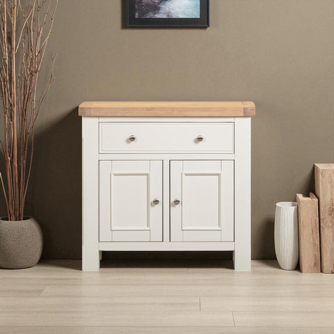 White cabinet with wooden top against a brown wall