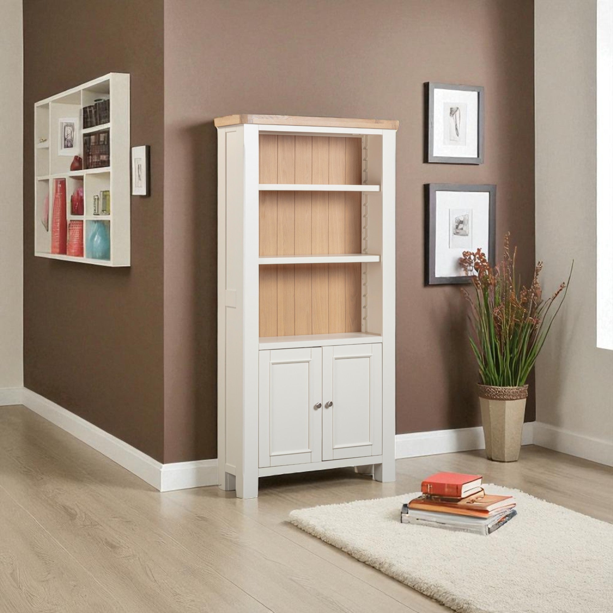 White bookshelf with wooden back against a brown wall with decorative elements.