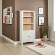 White bookshelf with wooden back against a brown wall with decorative elements.