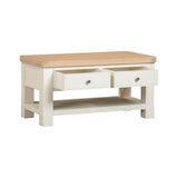 Wooden coffee table with two drawers on a white background