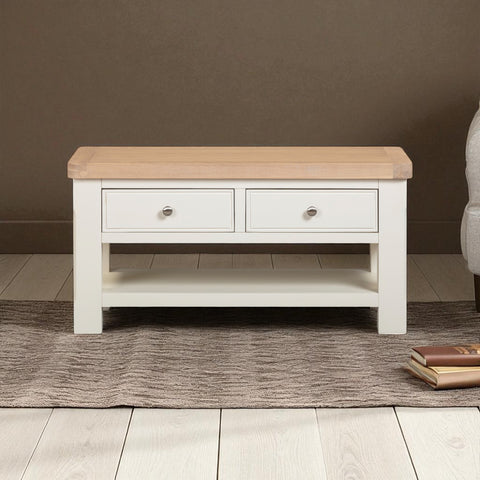 Wooden coffee table with two drawers on a wooden floor.