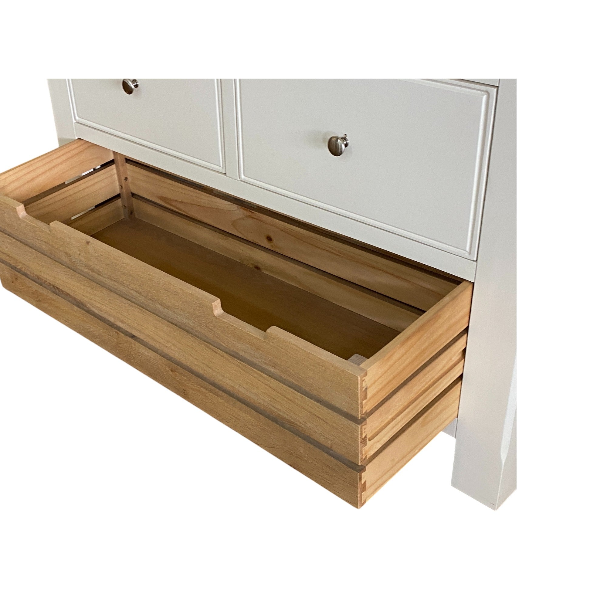Wooden drawer being pulled out from a white cabinet.
