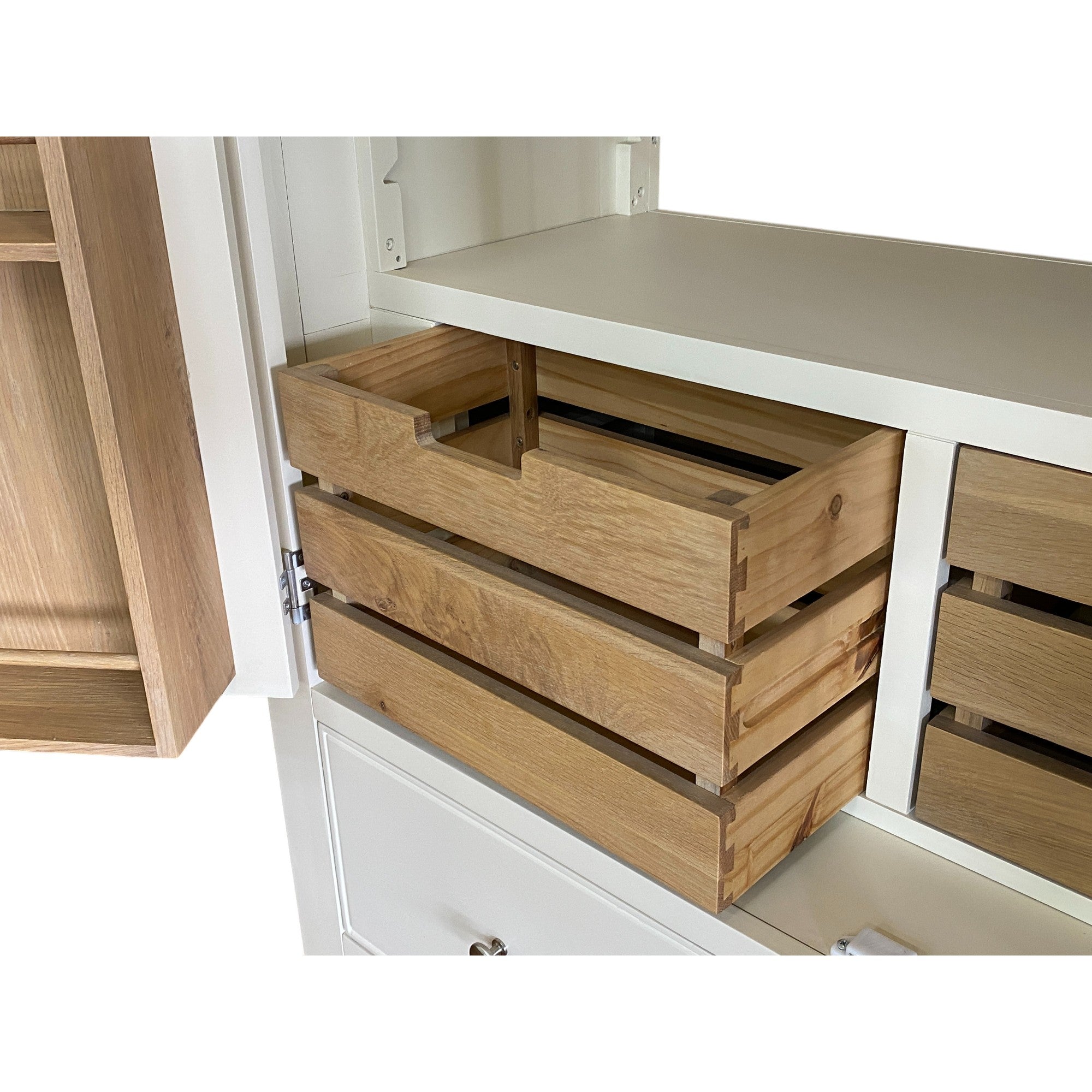 Wooden drawers inside a kitchen cabinet with a white interior.