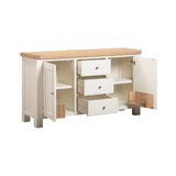 Wooden dresser with multiple drawers and open doors on a white background