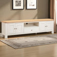 White TV stand with wooden top in a room with framed pictures on the wall.