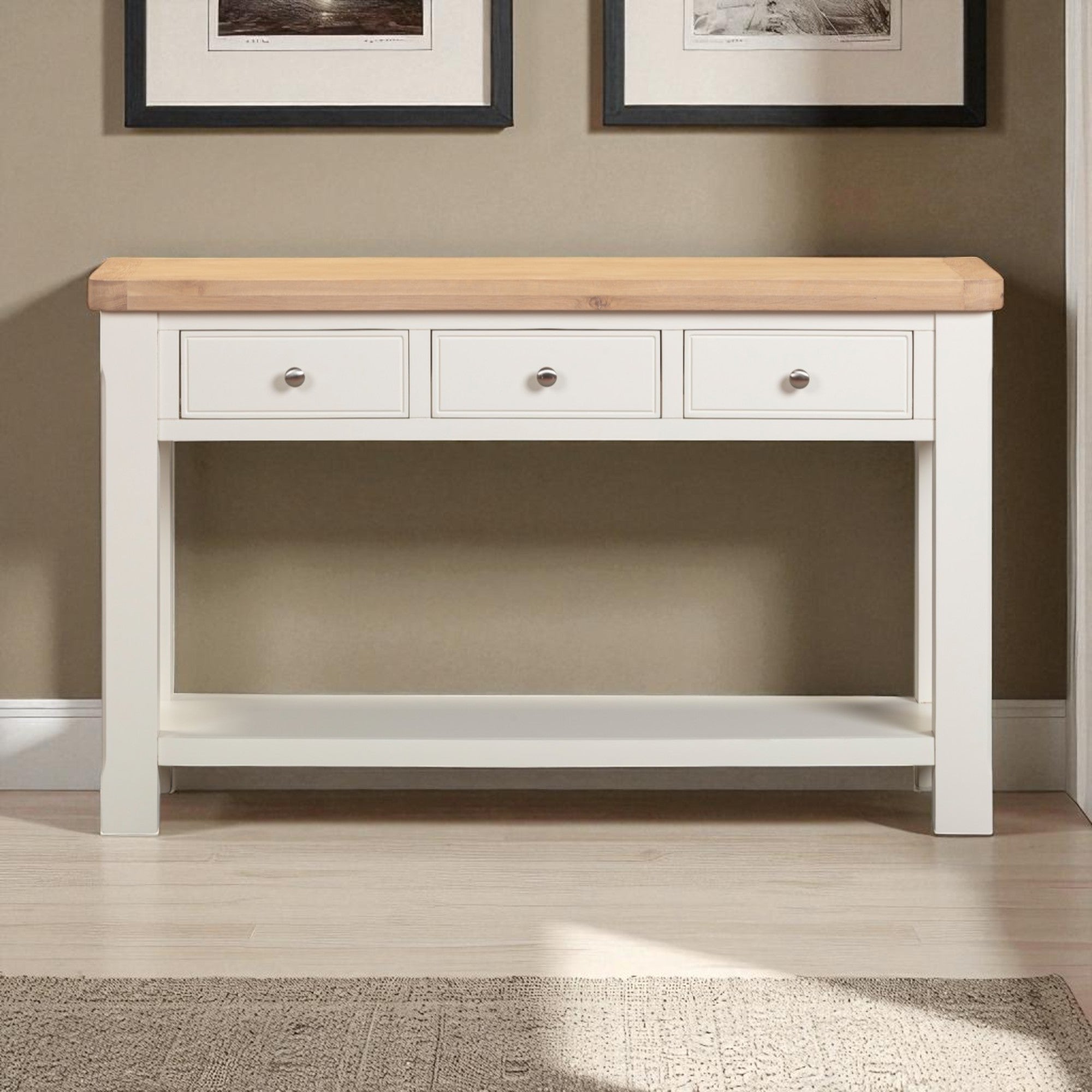 White console table with wooden top against a wall with framed pictures.
