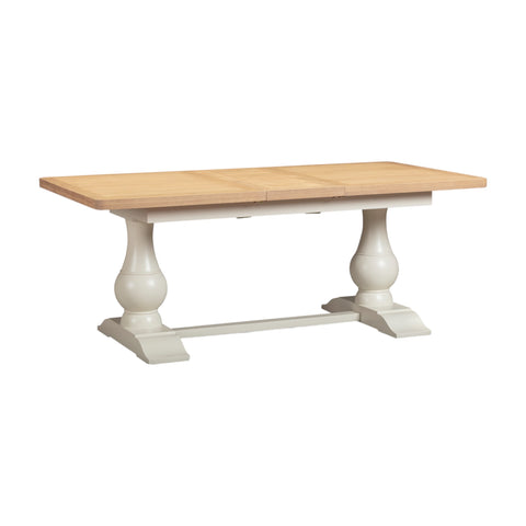 Wooden table with white pedestal base on a white background
