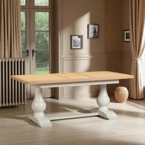 Wooden table with white legs in a room with curtains and a radiator.