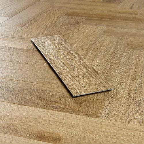 Weathered oak effect vinyl flooring plank on herringbone wood floor background