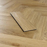 Weathered oak effect vinyl flooring plank on herringbone wood floor background