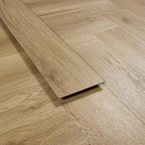 Weathered cedar vinyl flooring plank on herringbone patterned wood-look floor