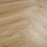 Weathered cedar effect laminate flooring in herringbone pattern, close-up angle