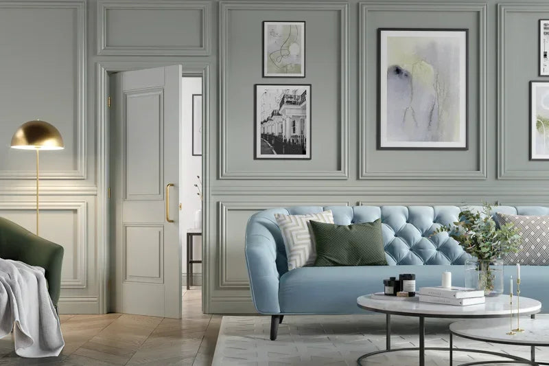 Light blue buttoned fabric sofa in classic living room with coffee tables and wall art