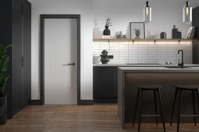 White Melbourne interior door with black frame in modern kitchen with island and stools