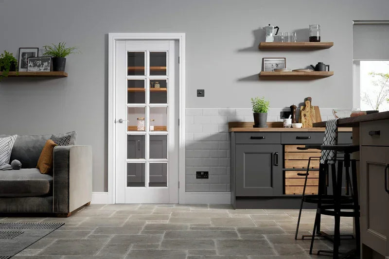 White moulded glazed internal door with glass panels in modern grey kitchen and living area