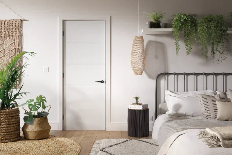 White primed Santandor door with horizontal grooves in a modern bedroom with indoor plants