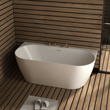 White freestanding bathtub in a bathroom with wooden walls and floor.