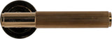 Bright coffee door handle with grooved brass finish shown from the side