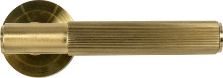 Matt brass door handle with ribbed grip and round rose, modern home hardware