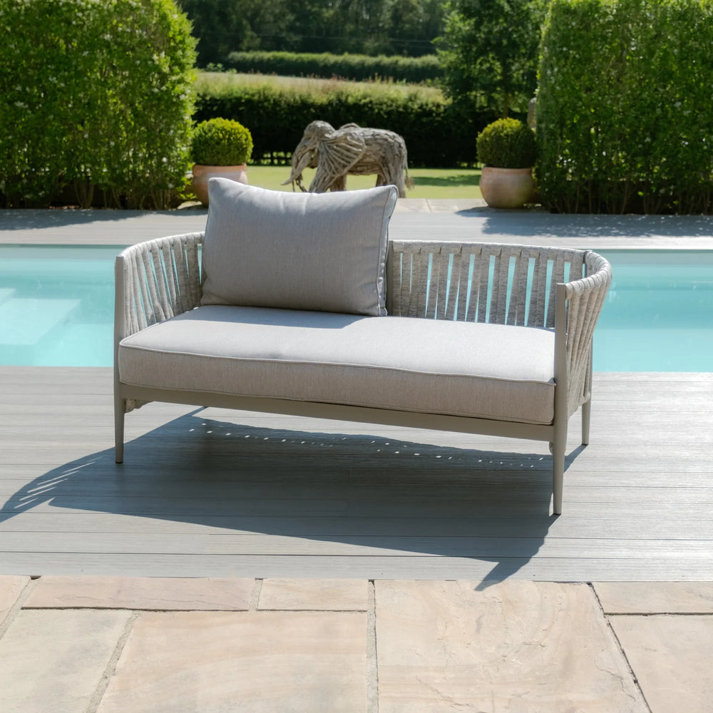 Light grey outdoor sofa with rope detailing and cushion by swimming pool