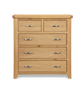 Oak chest of drawers with five drawers and metal handles, front view