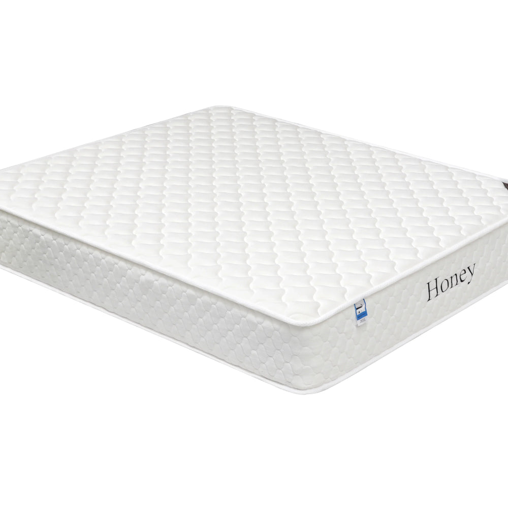 white honey mattress with quilted top and side label, shown at angled view