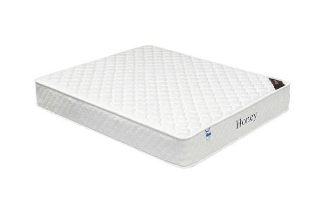white honey mattress with quilted top and side label, shown at angled view