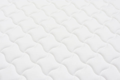 White mattress surface with wave quilted pattern for bedroom furniture