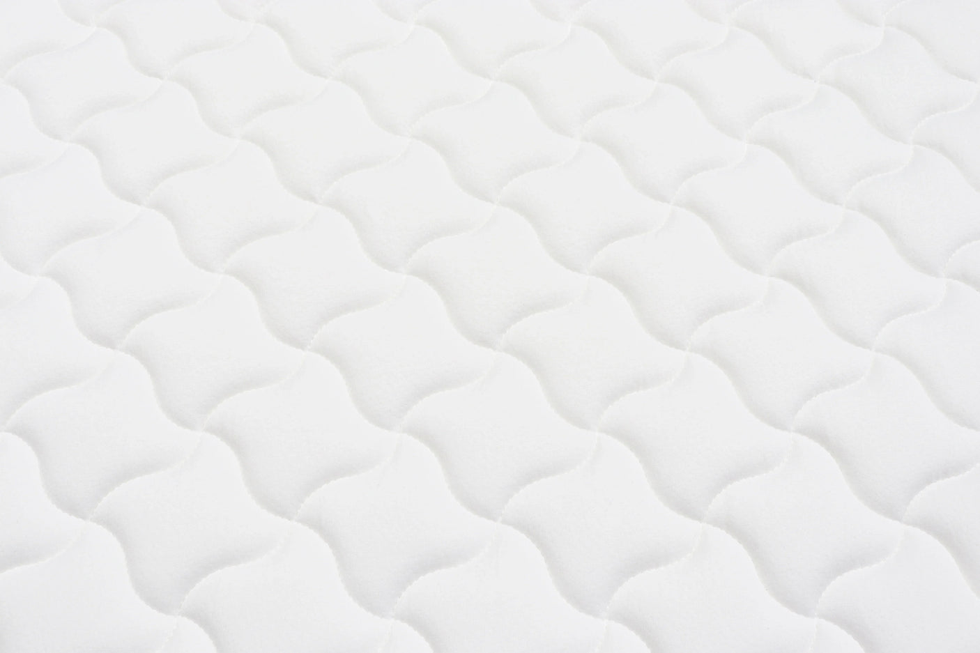 White mattress surface with wave quilted pattern for bedroom furniture