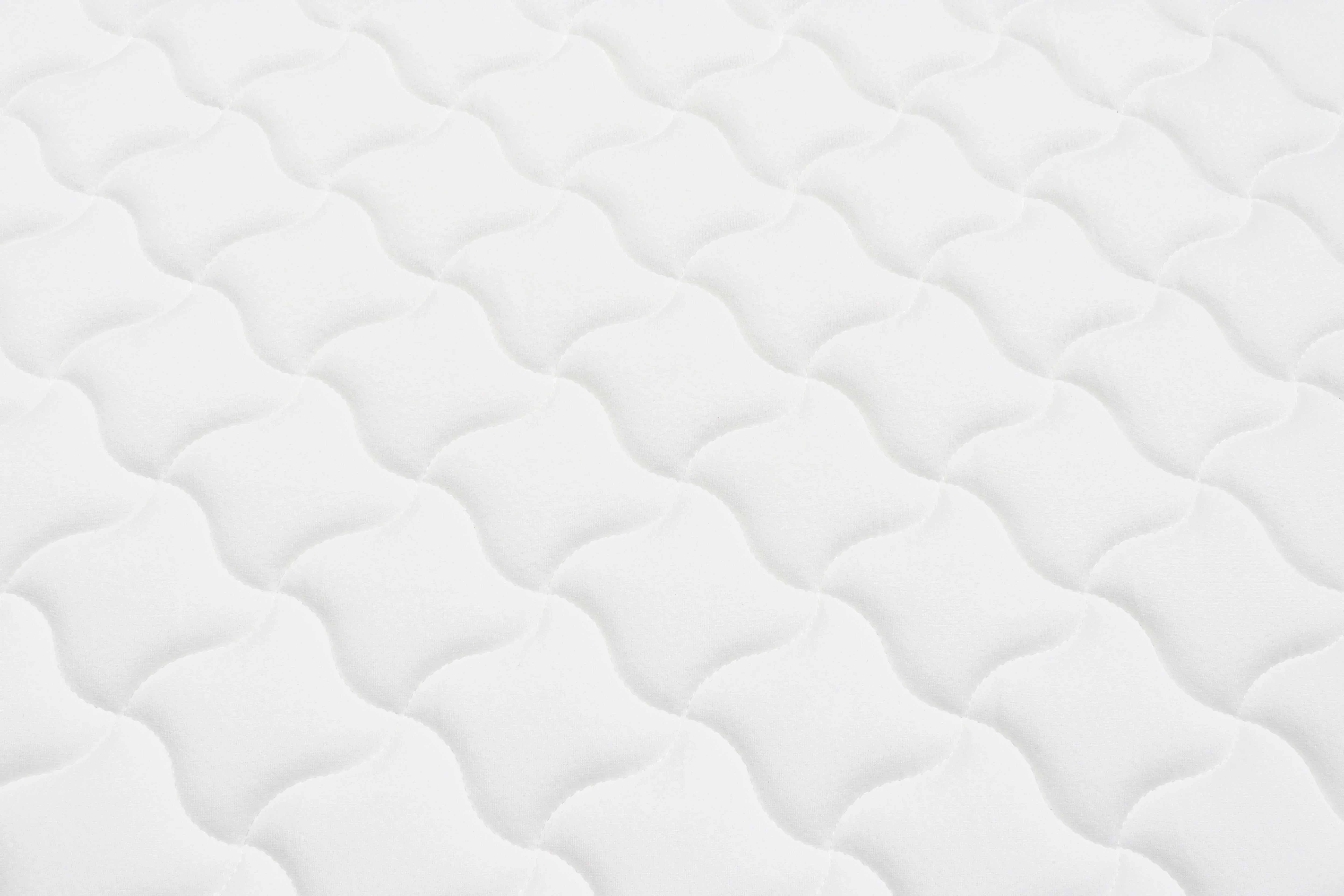 White mattress surface with wave quilted pattern for bedroom furniture