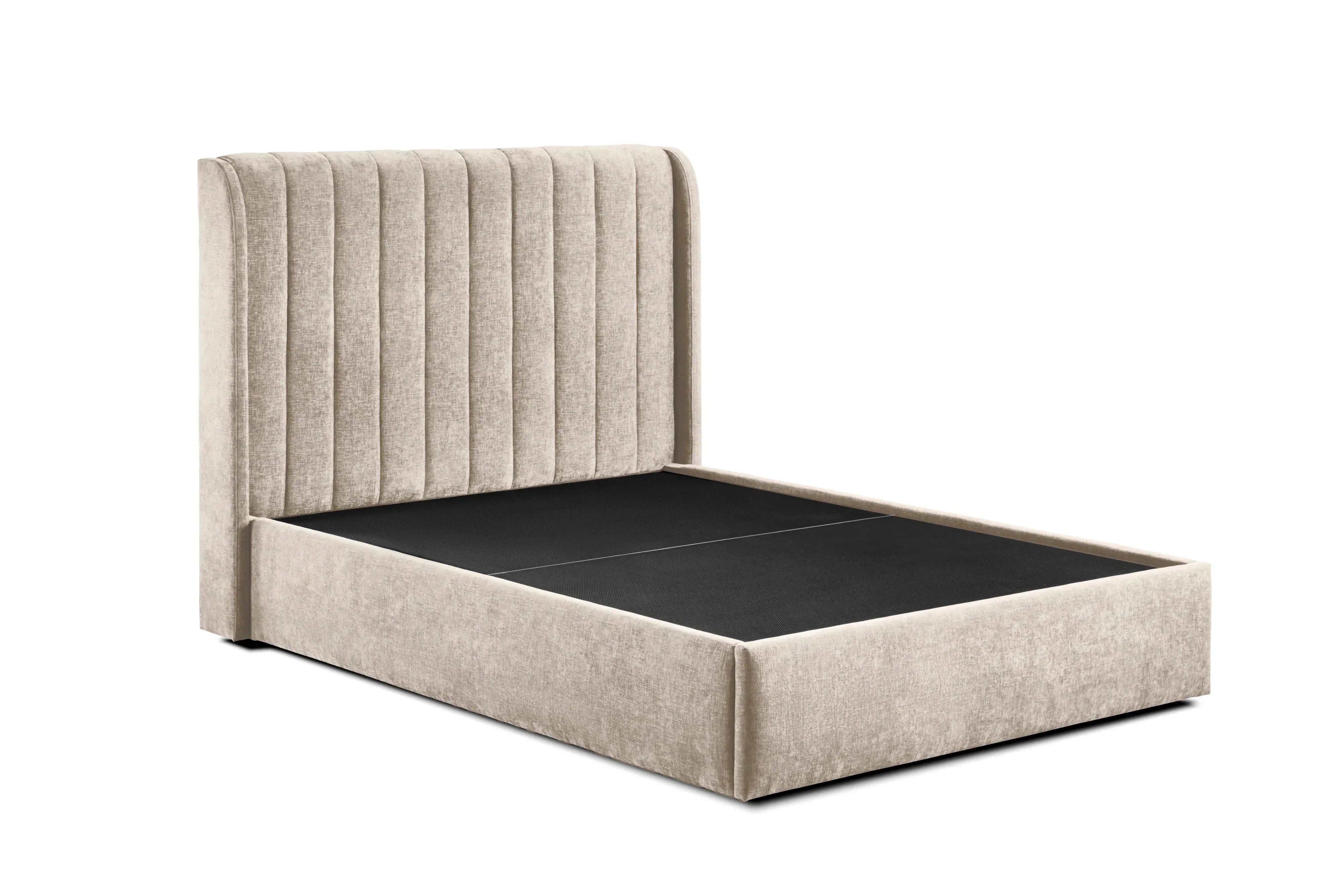 Beige upholstered bed frame with vertical panel headboard and black base, angled view