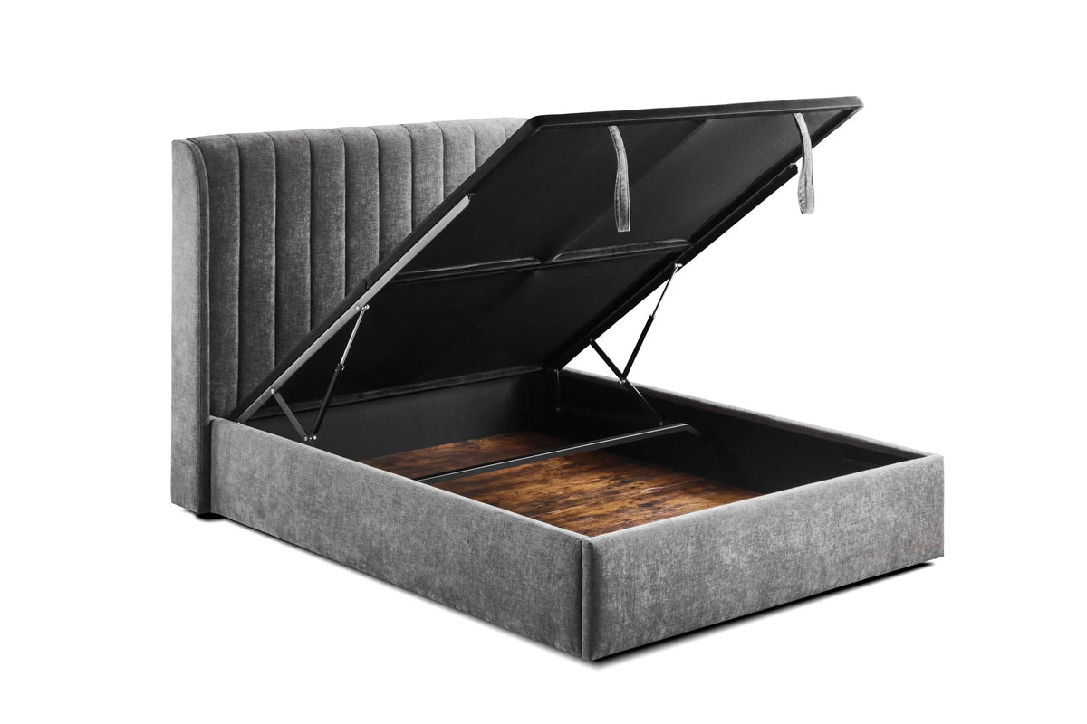 Grey upholstered ottoman bed frame with open storage compartment and vertical panel headboard