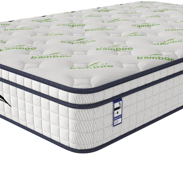 White bamboo mattress with quilted top and green leaf pattern, close-up corner view
