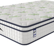 White bamboo mattress with quilted top and green leaf pattern, close-up corner view