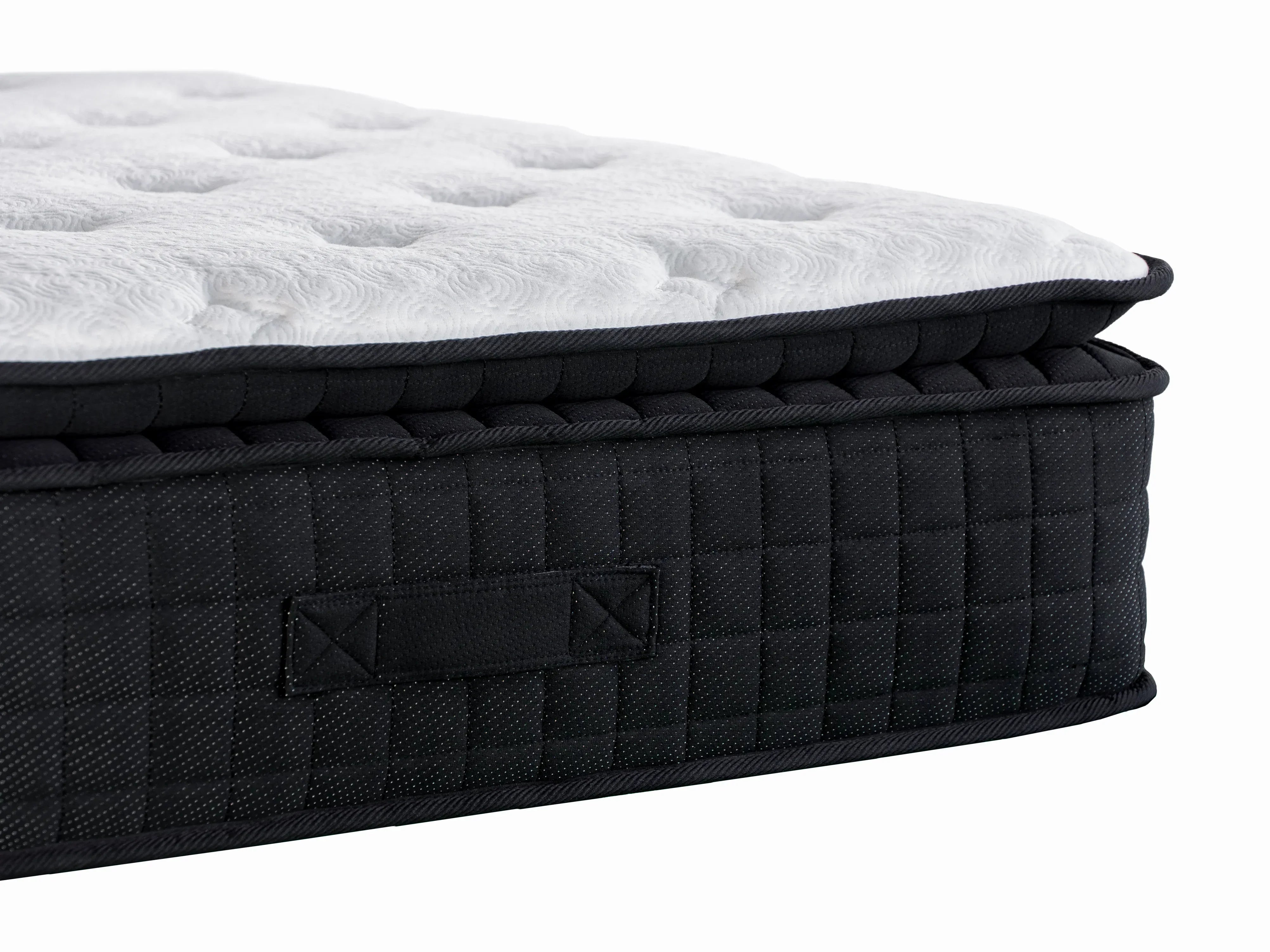 Closeup of double mattress with quilted black side panel and white tufted top