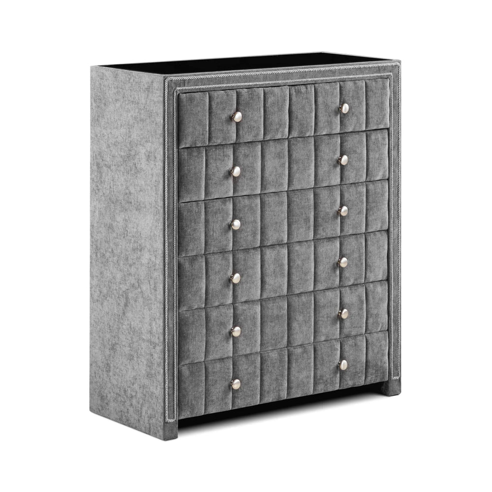 Grey fabric chest of drawers with tufted front and silver knobs, angled view