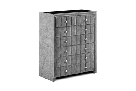 Grey fabric chest of drawers with tufted front and silver knobs, angled view