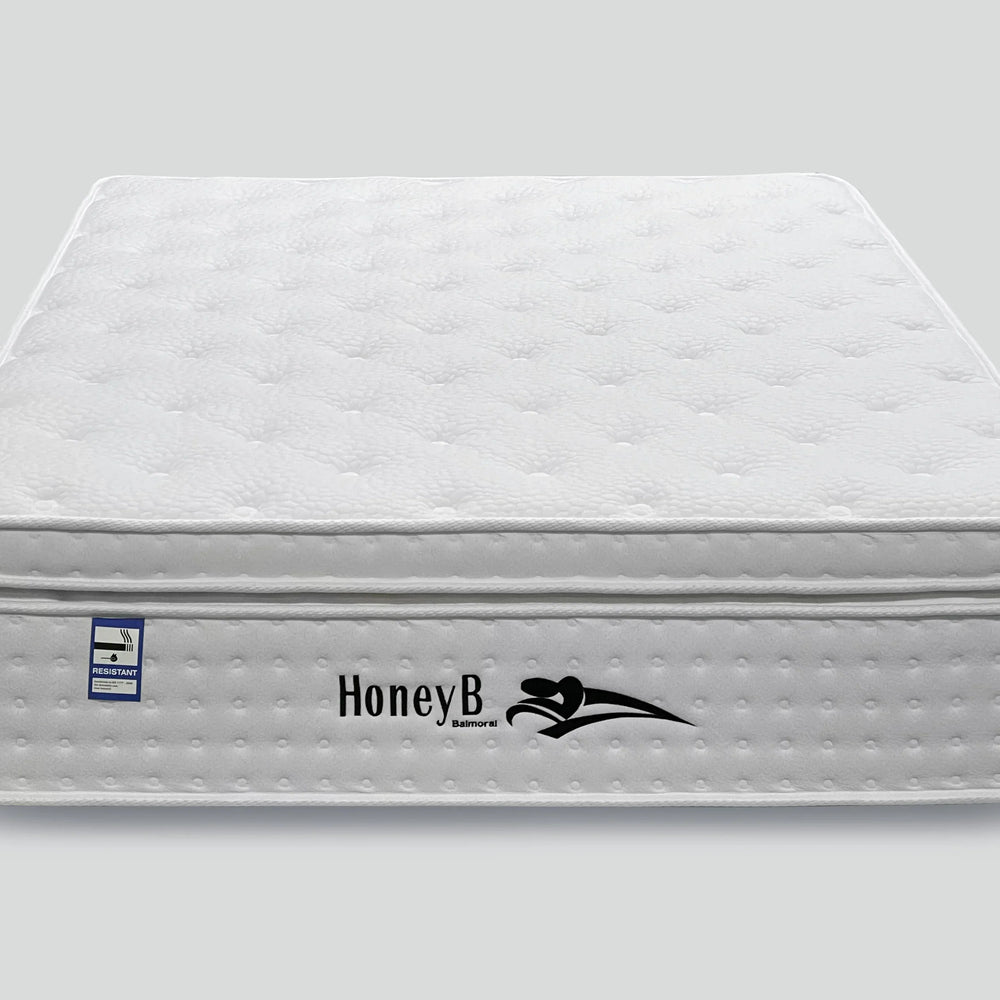White quilted mattress with pillow top and fire resistant label, front view