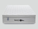White quilted mattress with pillow top and fire resistant label, front view