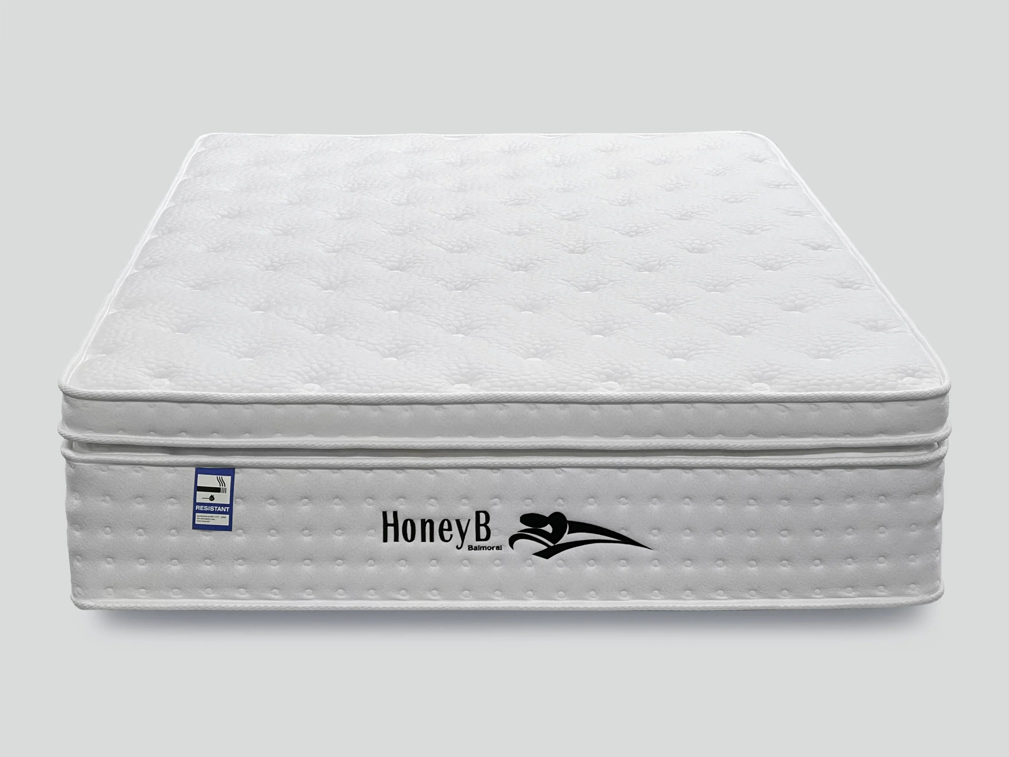White quilted mattress with pillow top and fire resistant label, front view
