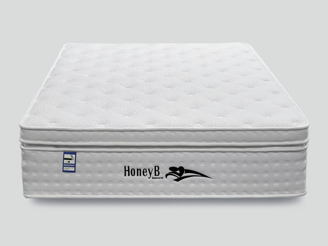 White quilted mattress with pillow top and fire resistant label, front view
