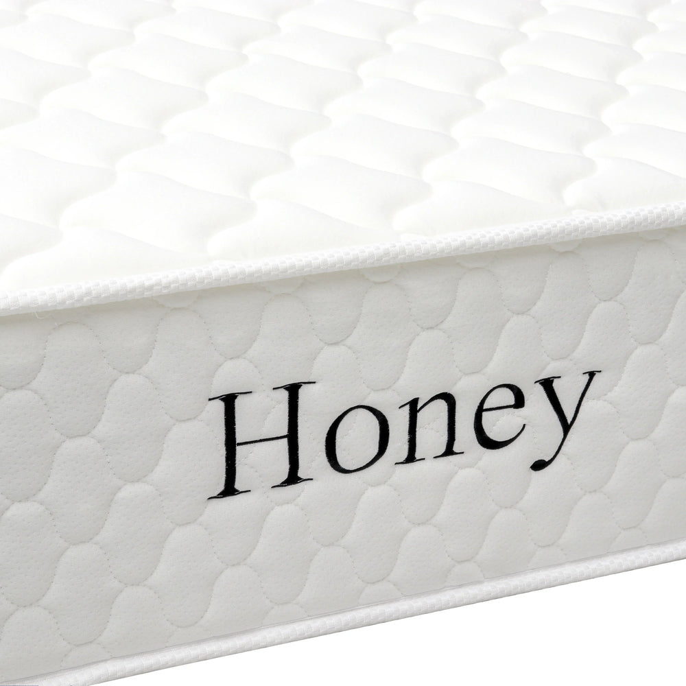 White quilted mattress side view with Honey text embroidered on fabric cover