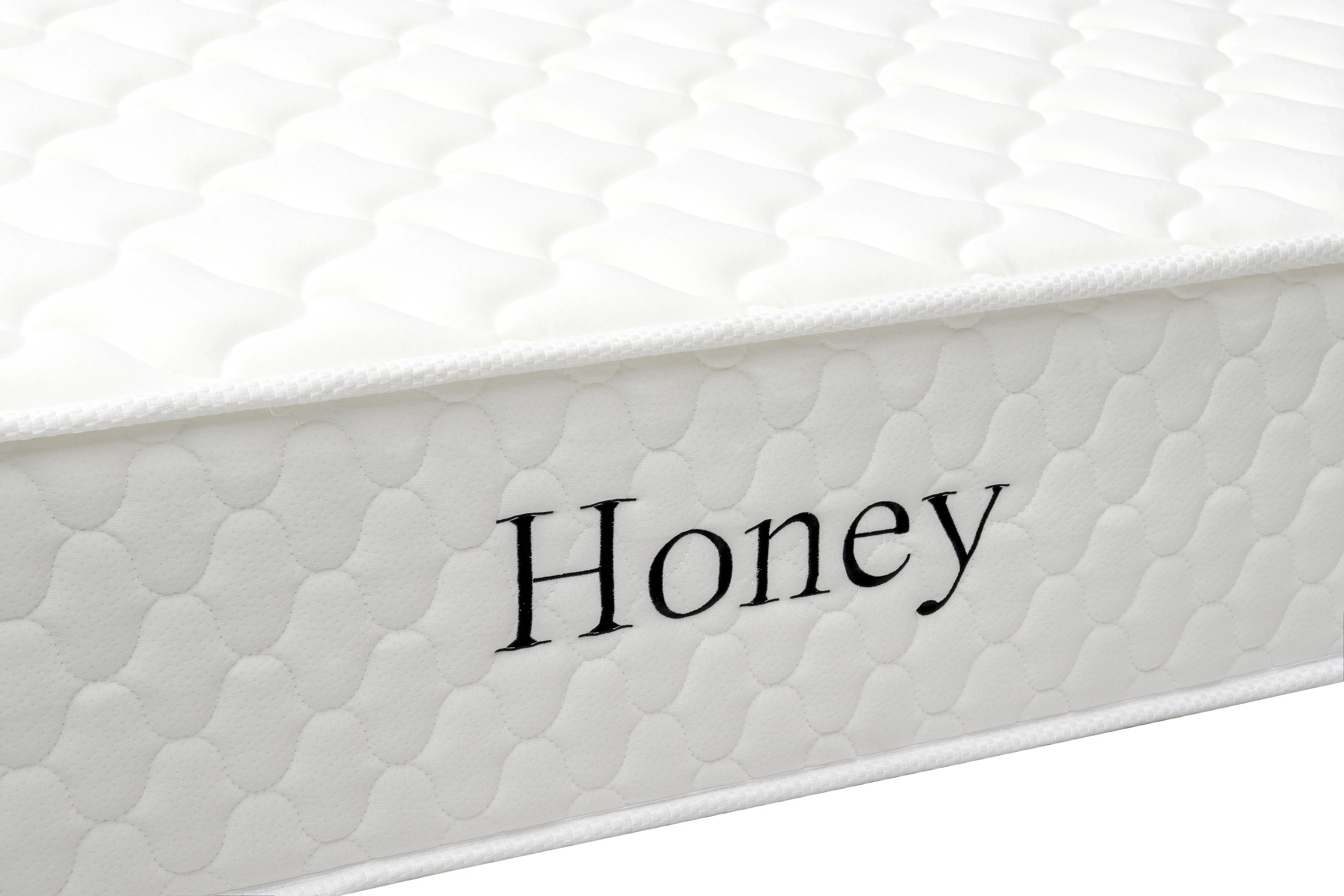 White quilted mattress side view with Honey text embroidered on fabric cover