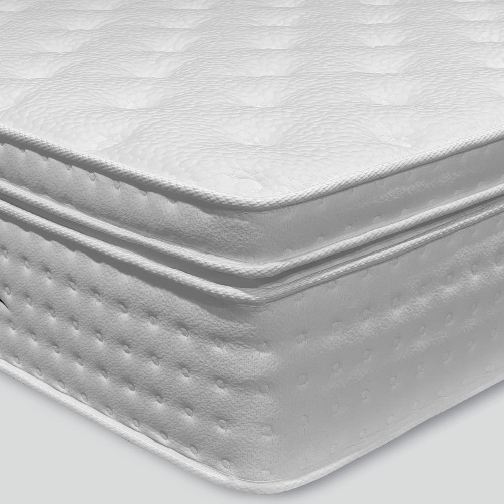 White quilted mattress with pillow top and stitched side detail
